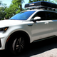 A side profile image of a white Kia Sorento plug-in Hybrid SUV.